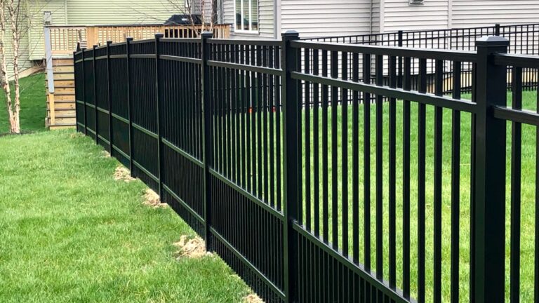 A straight, well-installed black aluminum fence — the standard to expect from a good fence repair company near you
